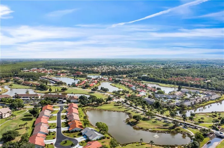 Birds eye view of property with a water view