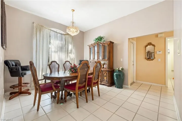 Dining room featuring suspended lighting and light tile patterned floors