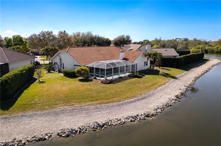 Drone / aerial view of a large body of water and a tree filled landscape