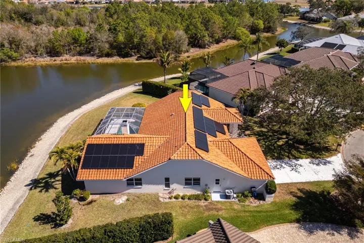 View from above of property featuring a large body of water and a tree filled landscape