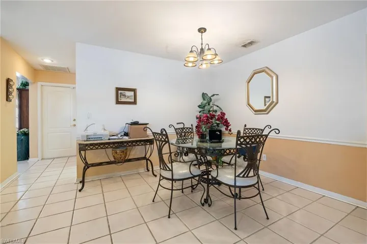 Dining room featuring light tile patterned floors and a chandelier