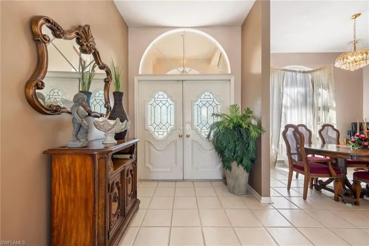 Entrance foyer featuring hanging lights and light tile patterned flooring