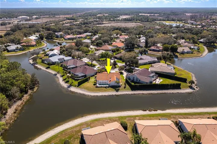 Aerial perspective of suburban area featuring a large body of water