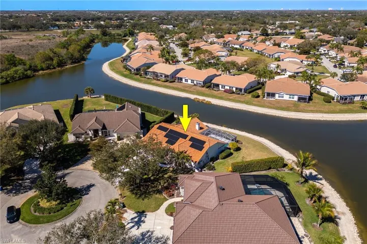 Aerial perspective of suburban area with a nearby body of water