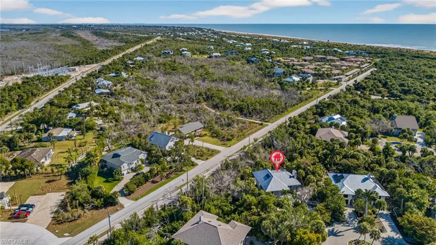 Aerial view of property and surrounding area with nearby suburban area