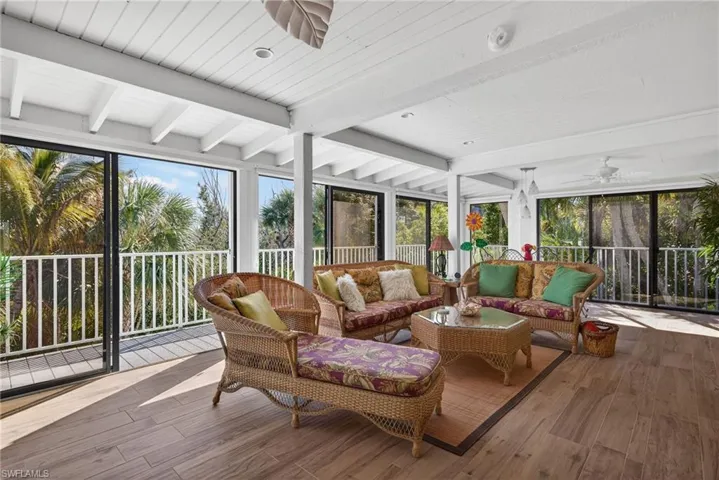 Family Room featuring ceiling fan, beamed ceiling, and outdoor lounge area