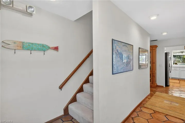 Stairway featuring tile patterned floors and baseboards