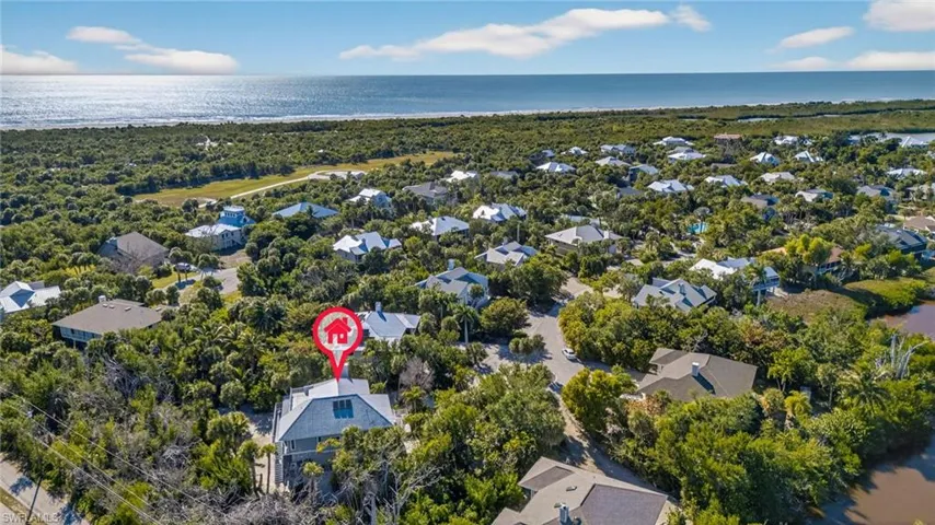 Aerial perspective of suburban area featuring a large body of water