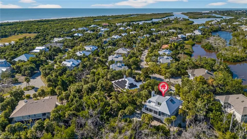 Aerial view of residential area featuring a large body of water