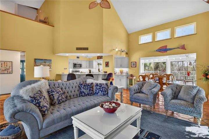 Living room with high vaulted ceiling and ceiling fan