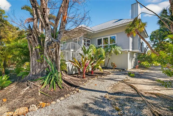 View of property exterior with a metal roof