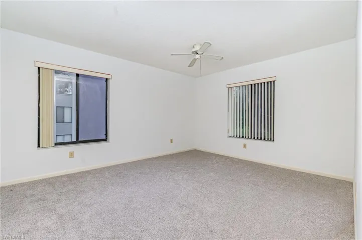 Empty room with carpet and a ceiling fan