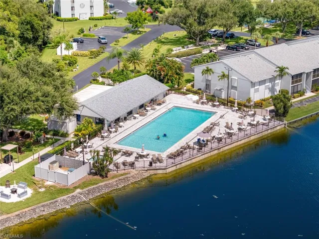 Drone / aerial view of the community pool which is situated beside the lake.