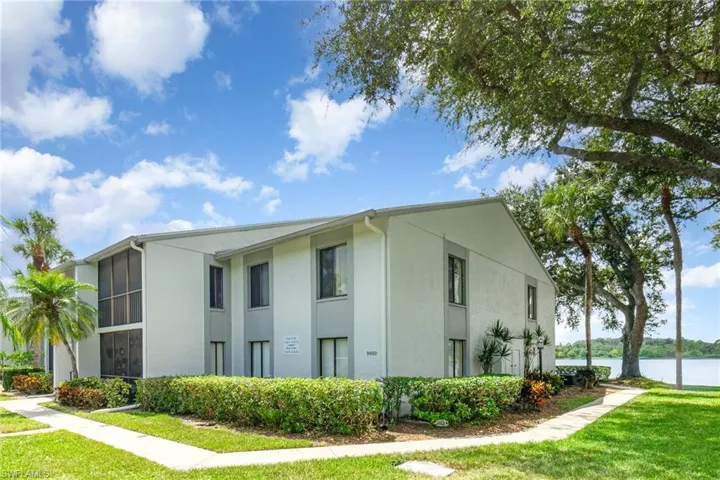 View of side of home featuring stucco siding and a yard