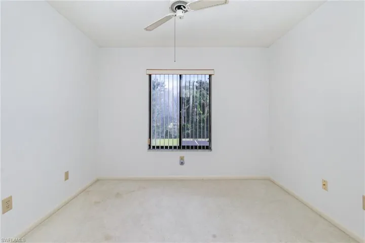 Guest room with carpet flooring and ceiling fan.