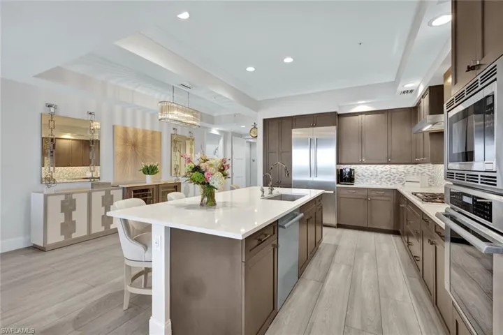 The large island is perfect for friends to gather around and partake in small bites and a favorite cocktail.