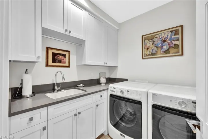 Laundry room with sink and additional storage space.  Stack the washer and dryer to add a second refrigerator.