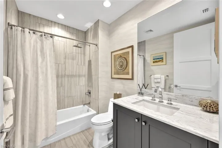 Ensuite bathroom with tub/shower combination.