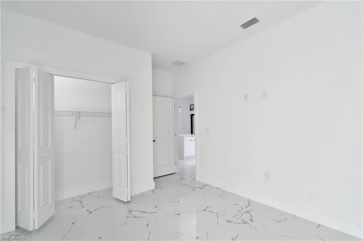 Unfurnished bedroom with a closet