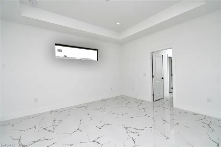 Unfurnished room featuring a raised ceiling