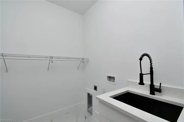 Laundry room with washer hookup, sink, and electric dryer hookup