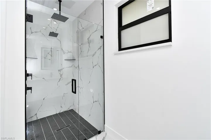 Bathroom with a shower with shower door