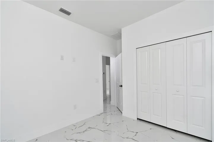Unfurnished bedroom with a closet