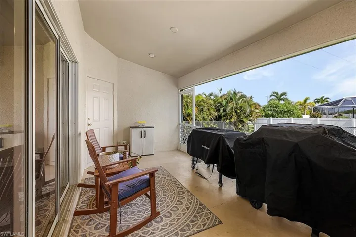 Kitchen with stainless steel appliances, white cabinets, and tile patterned floors