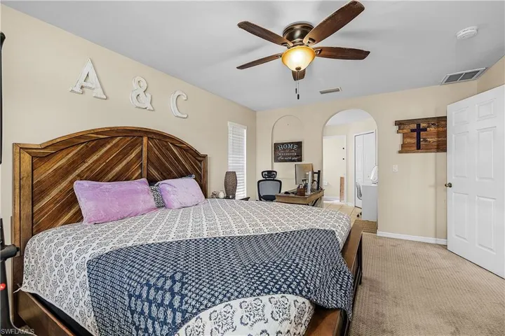 Kitchen with an open floor plan, white cabinets, stainless steel dishwasher, and healthy amount of natural light