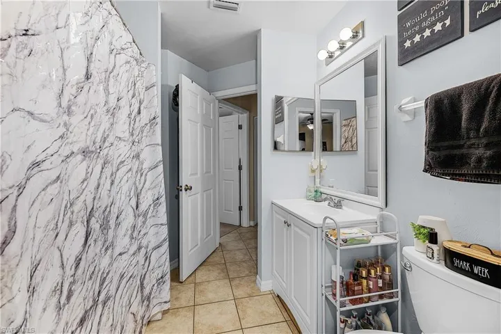 Bathroom featuring vanity, tile patterned floors, and a shower with shower curtain