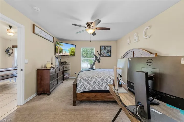 Laundry room with washing machine and dryer, tile patterned floors, and cabinet space