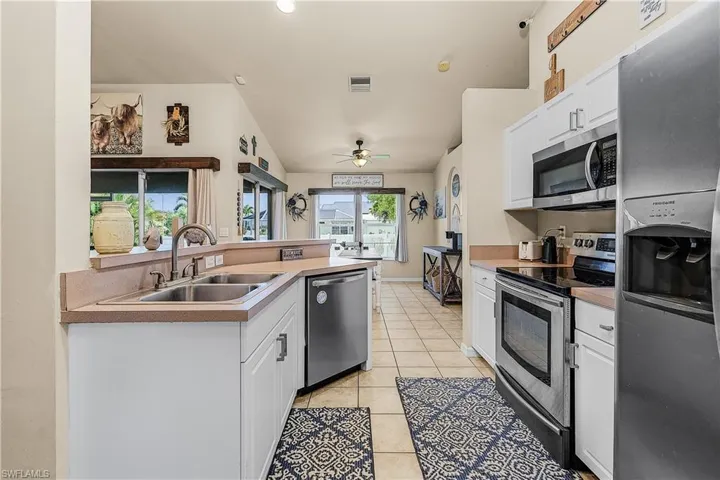 Bathroom with vanity, a ceiling fan, and tile patterned floors