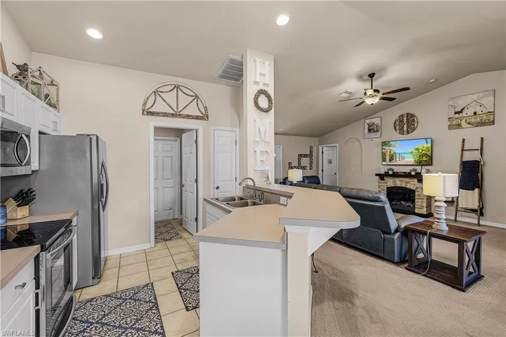 Carpeted bedroom with a ceiling fan