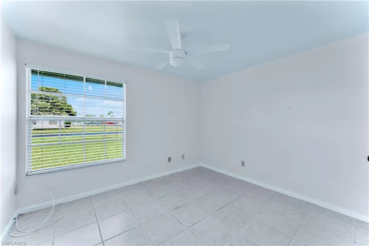 Unfurnished room featuring a ceiling fan and light tile patterned floors