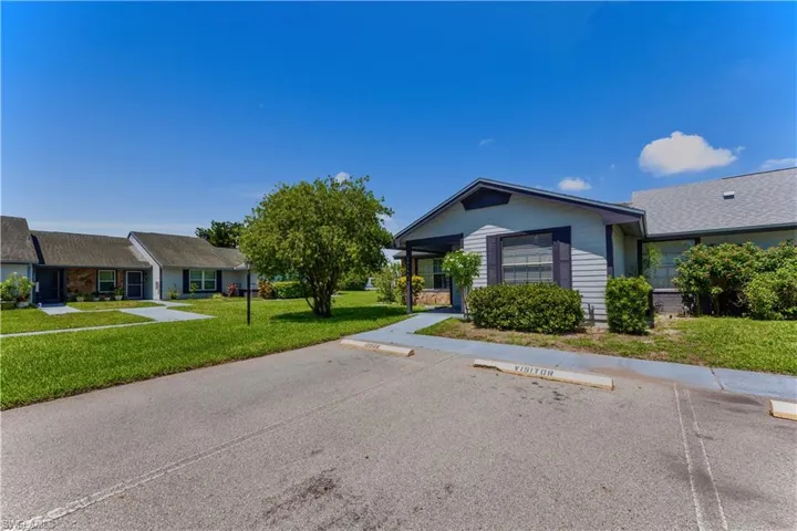 Ranch-style house with a front yard and uncovered parking