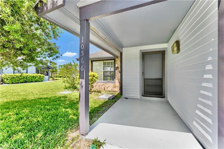 Entrance to property with a lawn