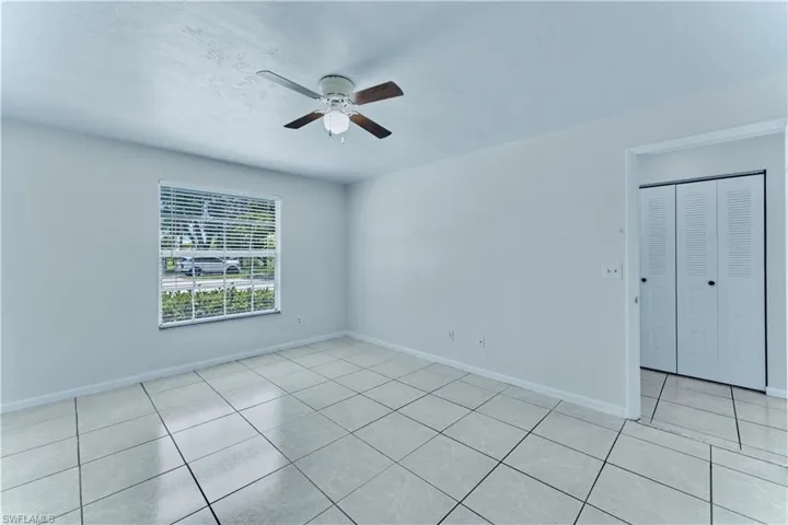Spare room featuring a ceiling fan and light tile patterned floors