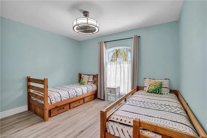 Bedroom featuring wood finished floors and baseboards