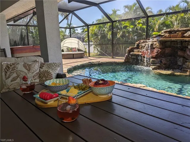 Outdoor pool with a lanai and a sunroom