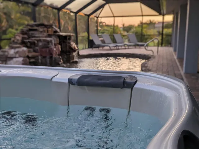 View of pool featuring a sunroom and a lanai