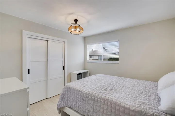 Bedroom featuring light wood-type flooring and a closet