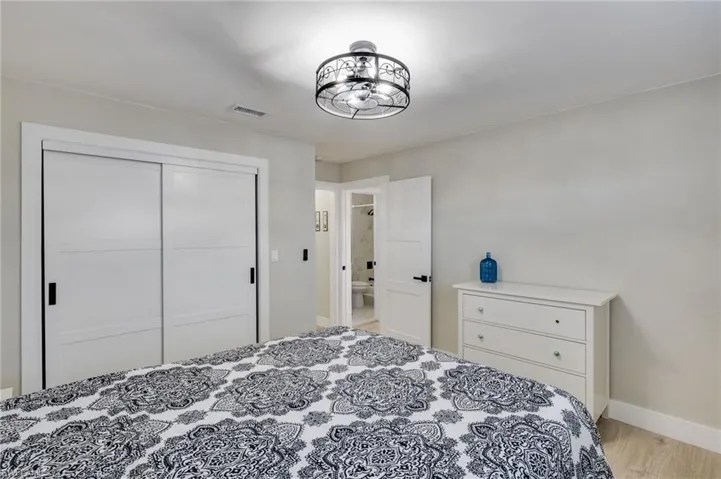 Bedroom with a closet and light wood-style flooring