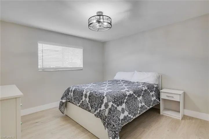 Bedroom featuring light wood finished floors and baseboards