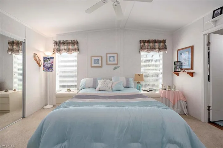 Bedroom with ceiling fan, a closet, carpet, and lofted ceiling