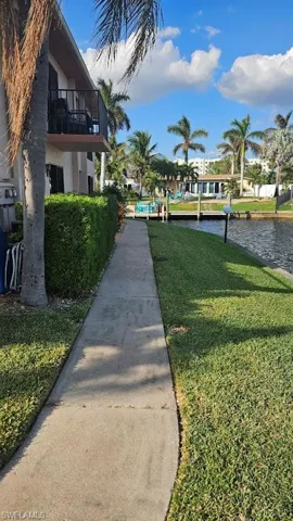 Surrounding community featuring a yard and a water view