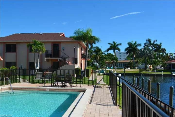 Community pool featuring stairs and a water view