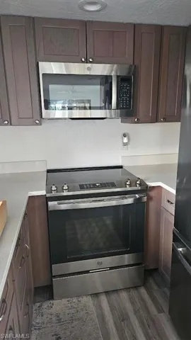 Kitchen featuring stainless steel appliances and light countertops