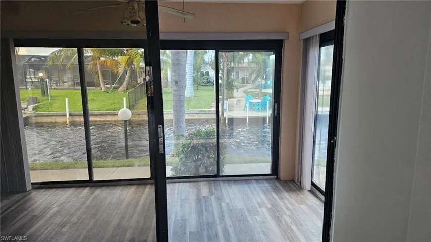 Living area with ceiling fan and wood finished floors