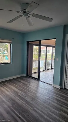 Bathroom with hardwood / wood-style floors and a shower with shower door