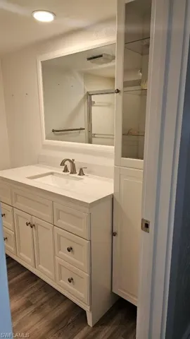 Bedroom featuring dark wood-style flooring and two closets